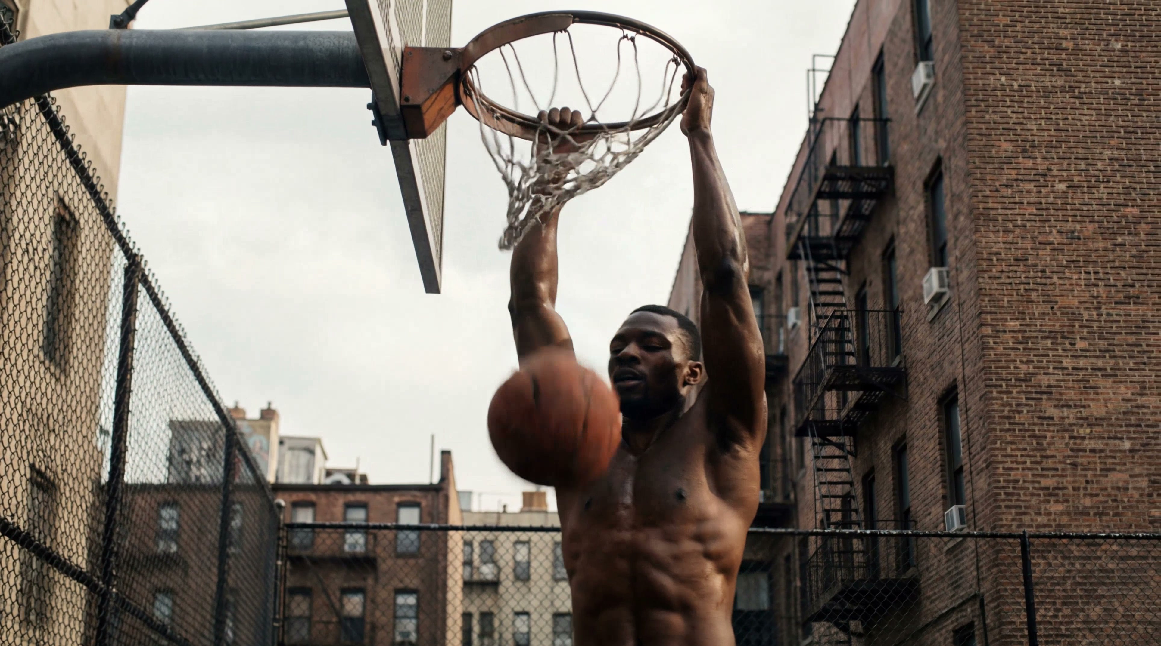 He throws the ball, captured in a slow lateral tracking shot with a gradual zoom-in. Cinematic motion, smooth camera movement, shallow depth of field, photorealistic, dynamic lighting.